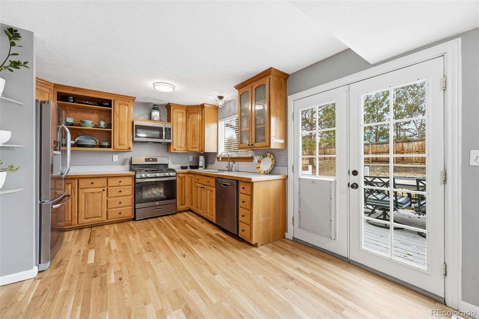 4993 East 111th Place Thornton, CO 80233 - Photo 14 of 50 a kitchen with stainless steel appliances a refrigerator and a stove top oven