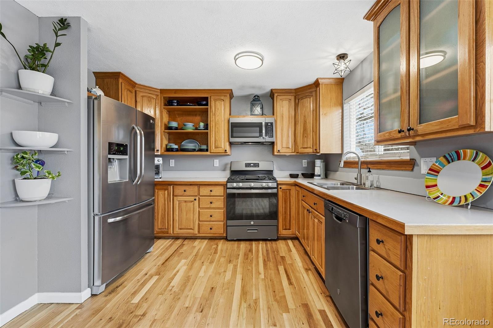 4993 East 111th Place Thornton, CO 80233 - Photo 15 of 50 a kitchen with stainless steel appliances granite countertop a refrigerator a stove and a sink