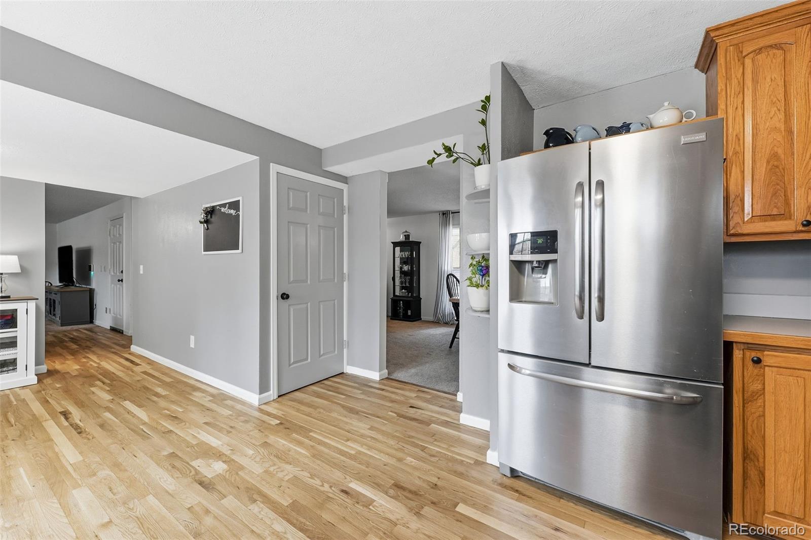 4993 East 111th Place Thornton, CO 80233 - Photo 17 of 50 a kitchen with stainless steel appliances a refrigerator and a stove top oven