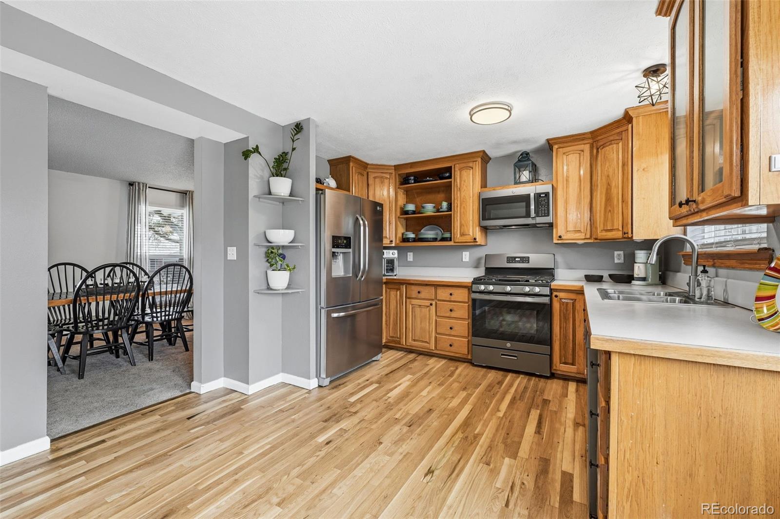 4993 East 111th Place Thornton, CO 80233 - Photo 18 of 50 a kitchen with stainless steel appliances granite countertop a refrigerator stove and sink