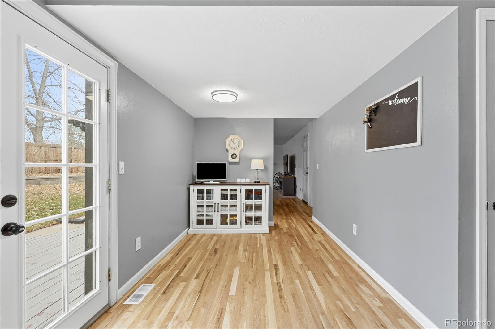 4993 East 111th Place Thornton, CO 80233 - Photo 19 of 50 a view of a bedroom with wooden floor and windows