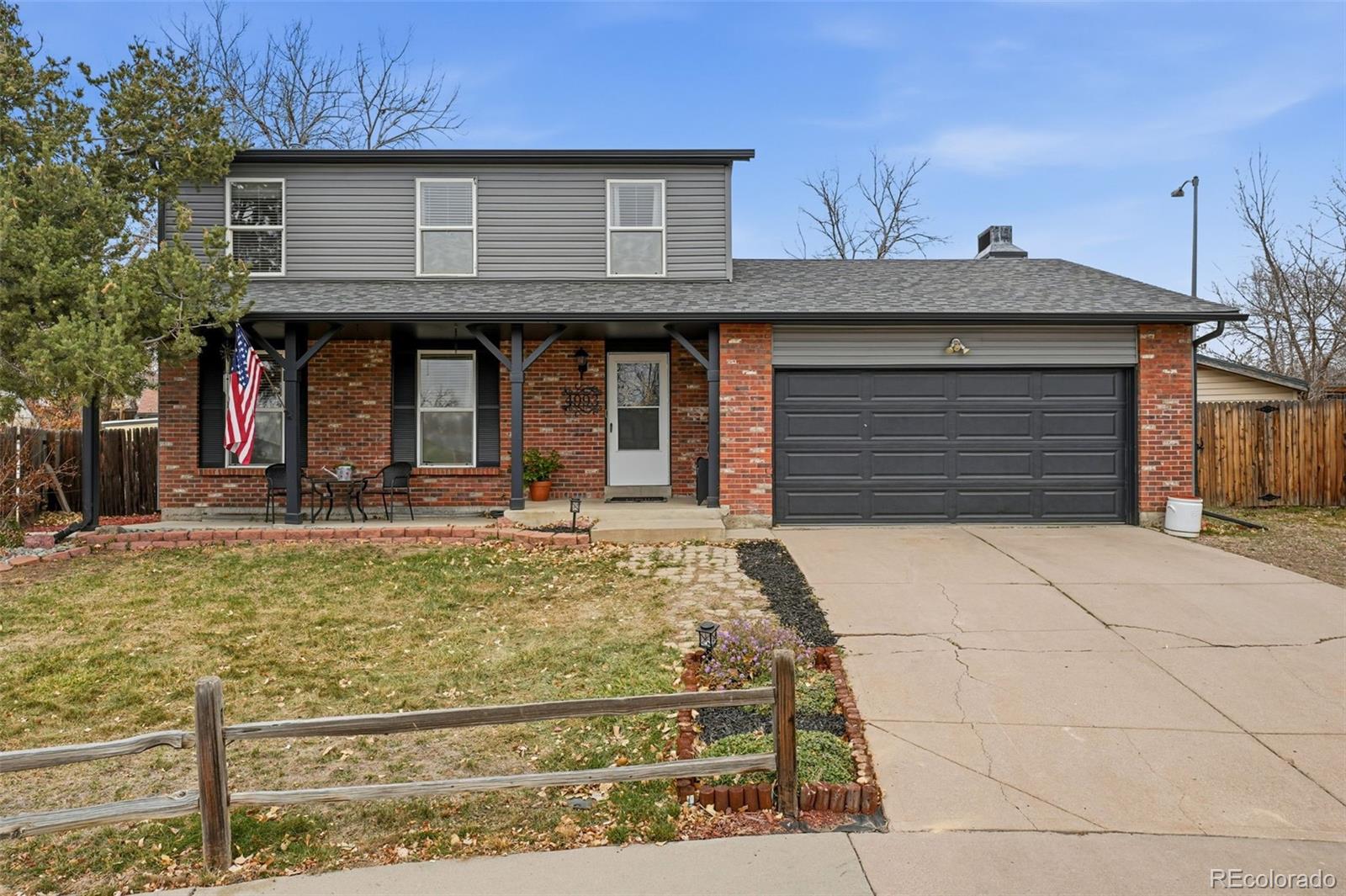 4993 East 111th Place Thornton, CO 80233 - Photo 2 of 50 a front view of a house with garage