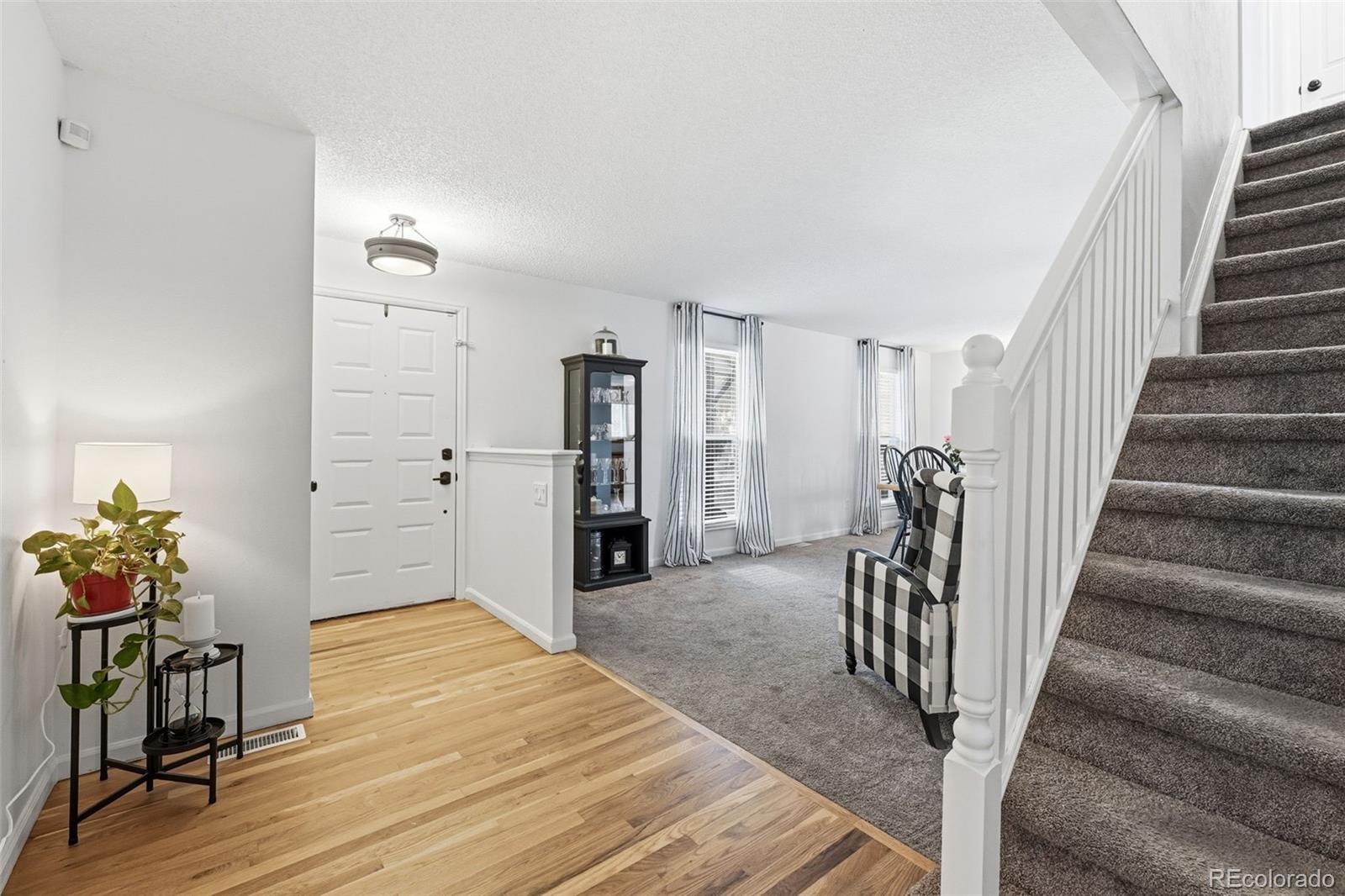 4993 East 111th Place Thornton, CO 80233 - Photo 21 of 50 a view of a livingroom with wooden floor and stairs