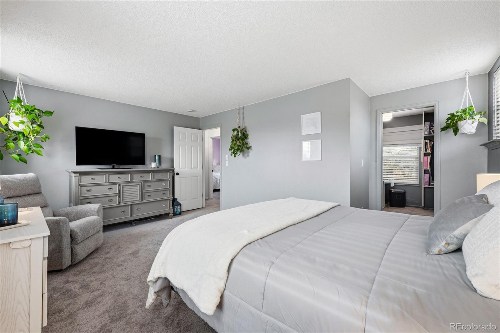 4993 East 111th Place Thornton, CO 80233 - Photo 23 of 50 a bedroom with bed tv and window