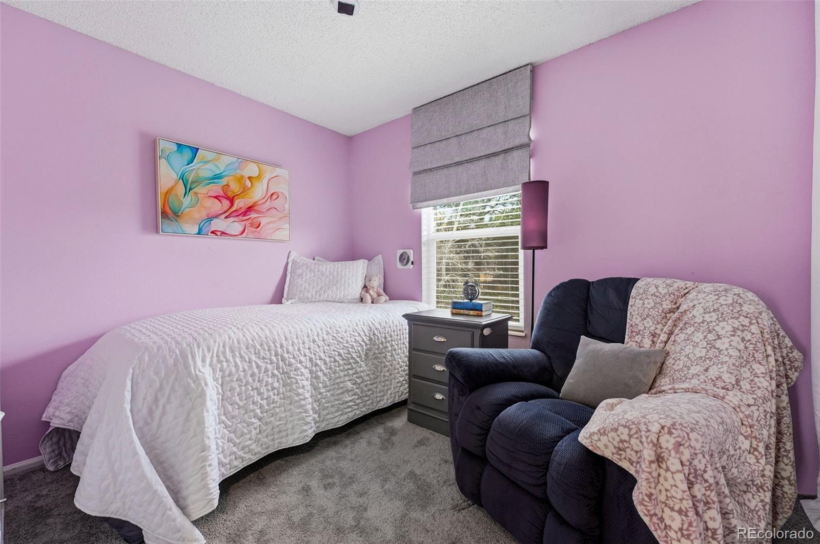 4993 East 111th Place Thornton, CO 80233 - Photo 25 of 50 a bedroom with a bed and a couch