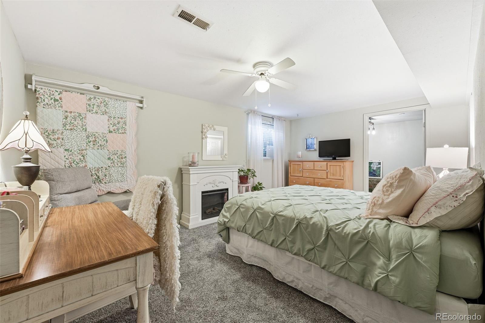 4993 East 111th Place Thornton, CO 80233 - Photo 30 of 50 a bed room with a bed and a fireplace