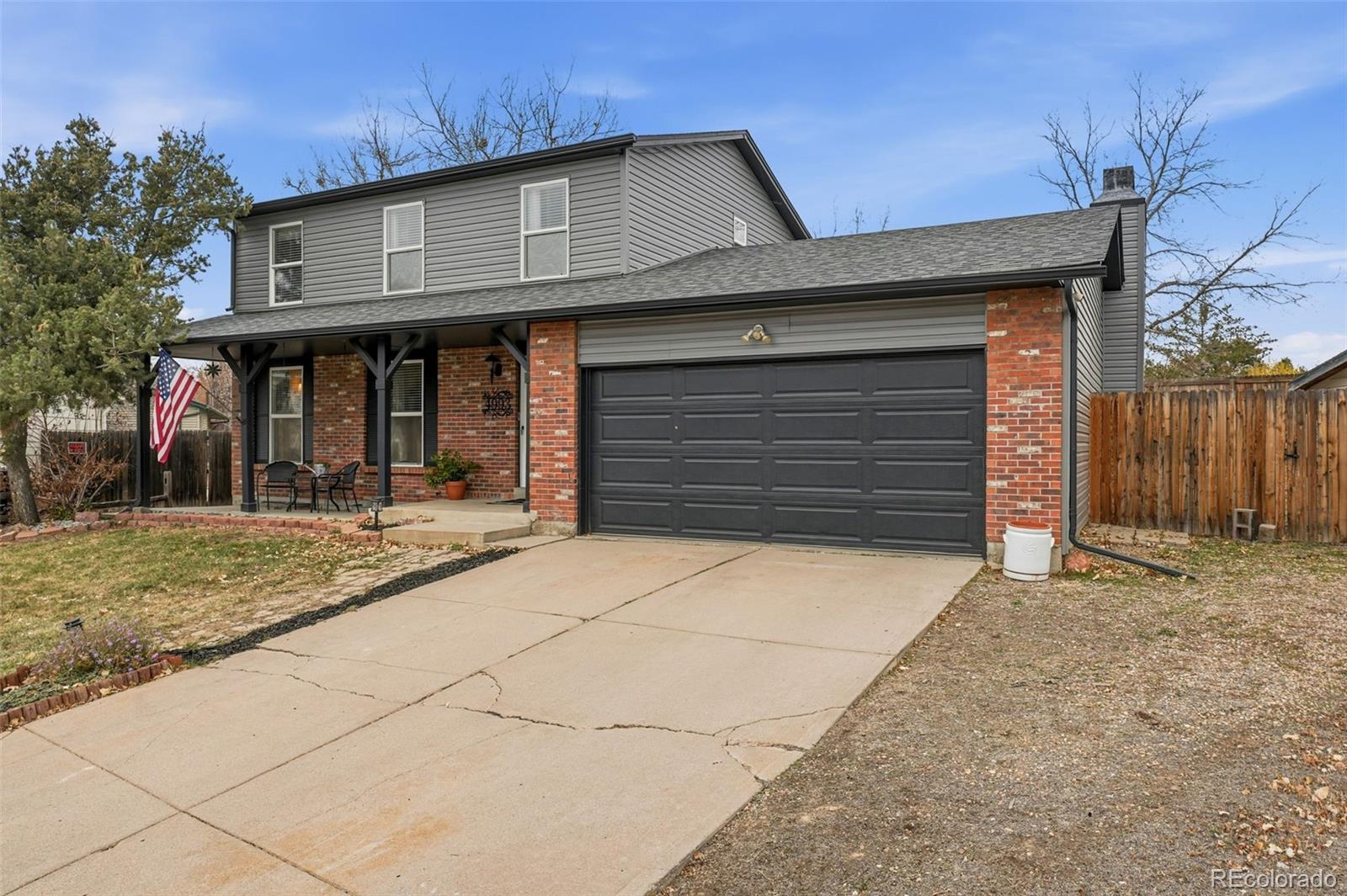4993 East 111th Place Thornton, CO 80233 - Photo 3 of 50 a front view of a house with a yard and garage