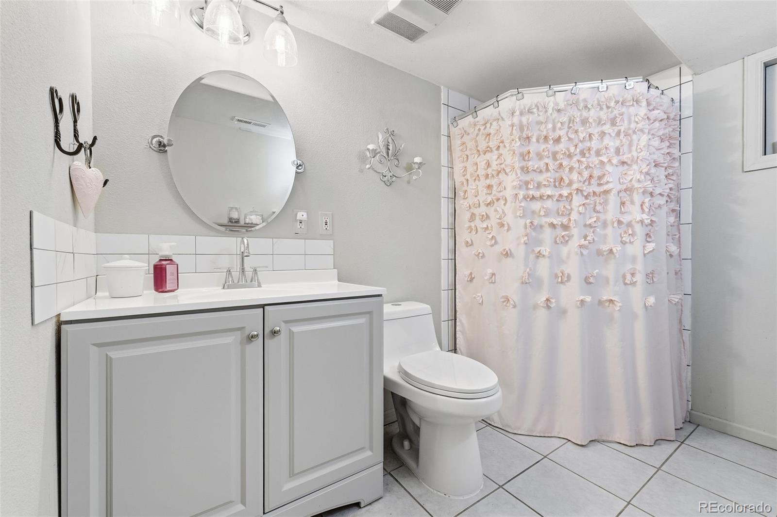4993 East 111th Place Thornton, CO 80233 - Photo 33 of 50 a bathroom with a sink toilet and shower