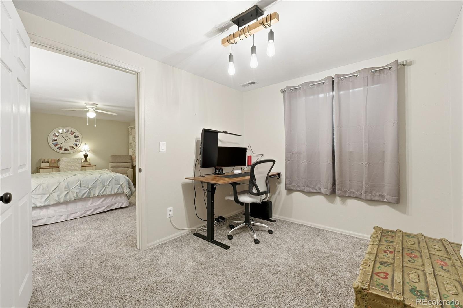 4993 East 111th Place Thornton, CO 80233 - Photo 34 of 50 a view of a livingroom with workspace and a couch