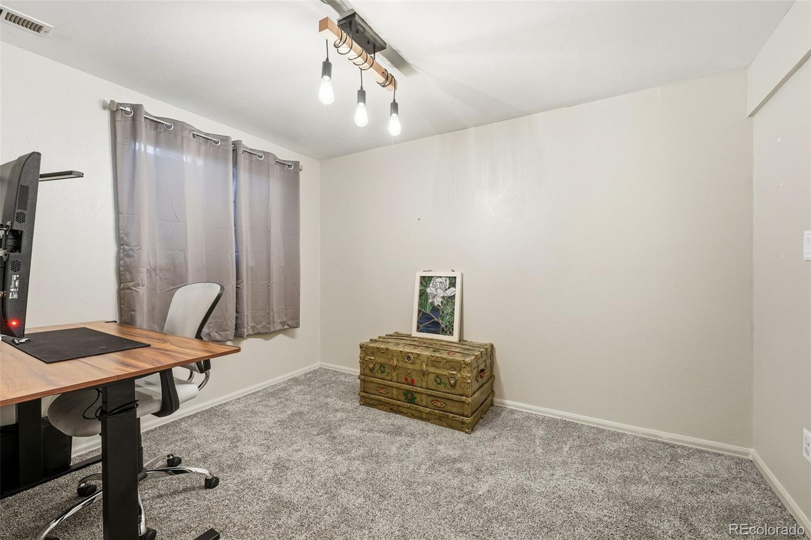 4993 East 111th Place Thornton, CO 80233 - Photo 35 of 50 a view of workspace with furniture