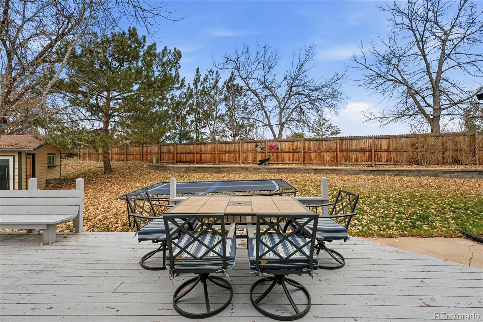 4993 East 111th Place Thornton, CO 80233 - Photo 38 of 50 a view of a chairs and table on the deck with wooden floor