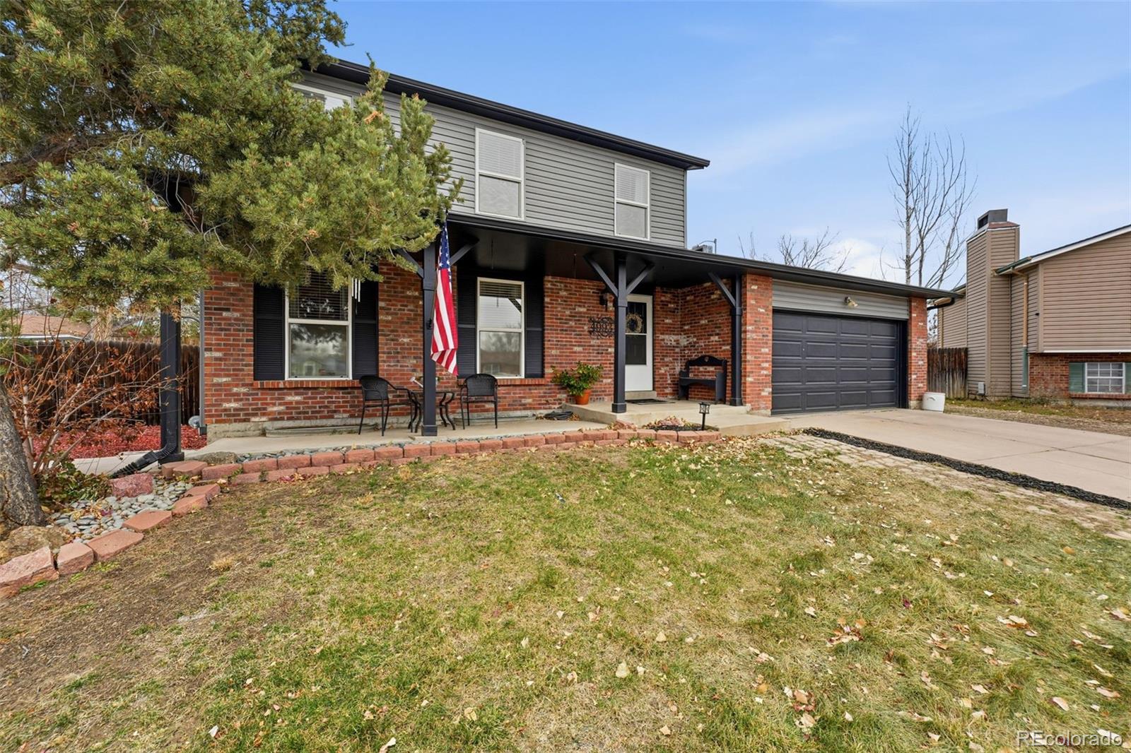 4993 East 111th Place Thornton, CO 80233 - Photo 4 of 50 a view of a house with a large tree