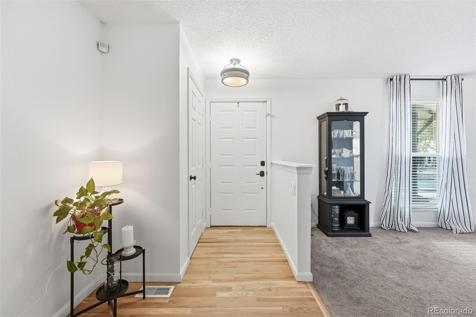 4993 East 111th Place Thornton, CO 80233 - Photo 6 of 50 a view of a hallway to a livingroom with furniture