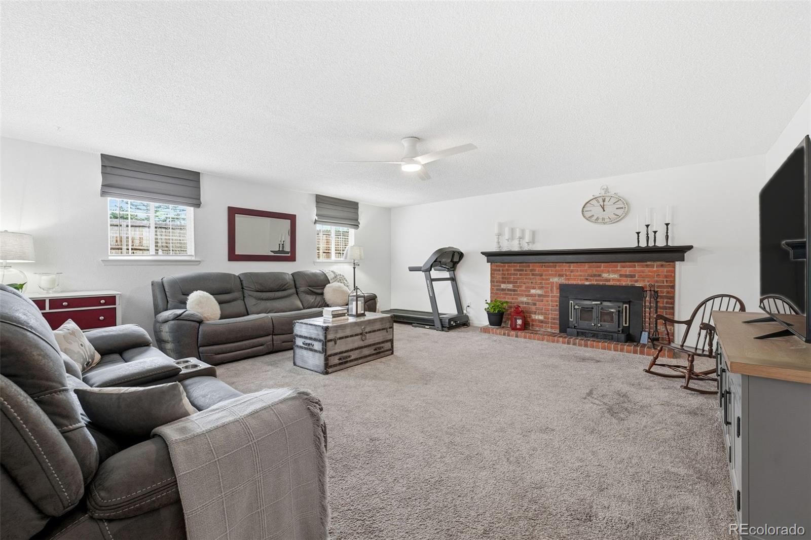 4993 East 111th Place Thornton, CO 80233 - Photo 10 of 50 a living room with furniture and a fireplace