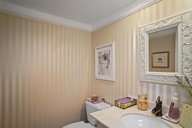 a bathroom with a sink a toilet and mirror