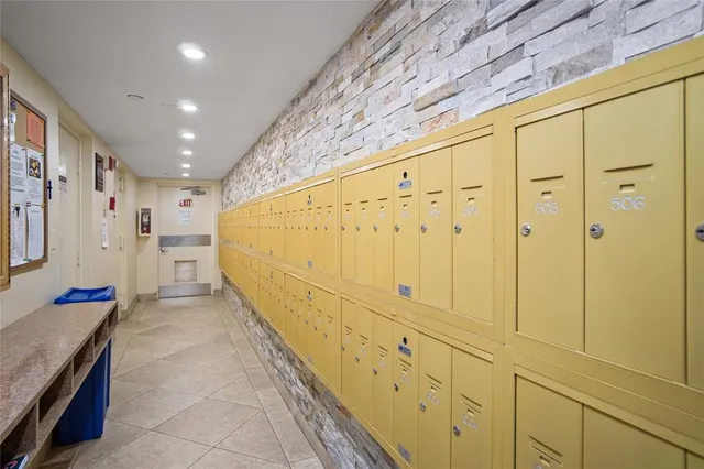 a view of walk in closet with wooden floors
