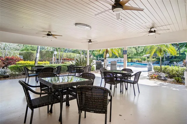 a view of a patio with a table chairs and backyard