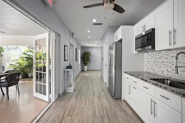 a view of a kitchen center island cabinets and stainless steel appliances