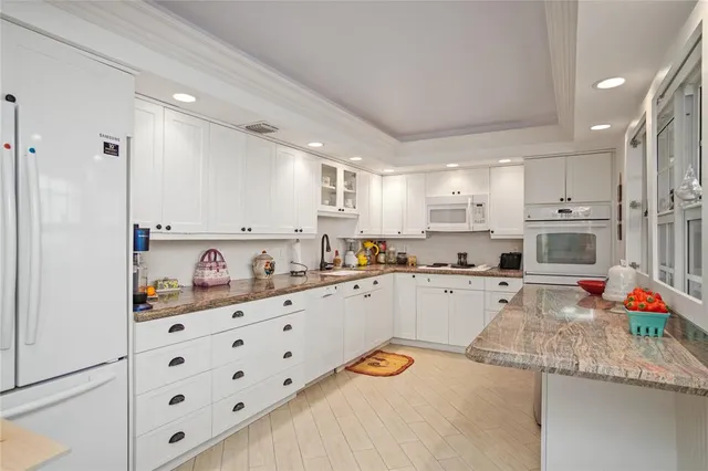 a kitchen with stainless steel appliances kitchen island granite countertop a sink and cabinets