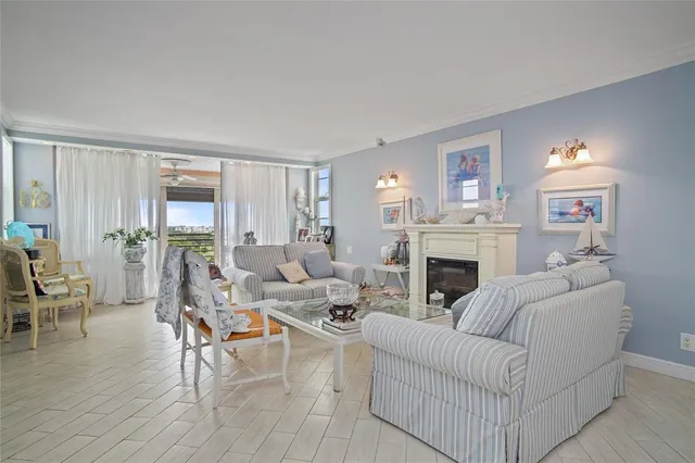 a living room with furniture a fireplace and a window