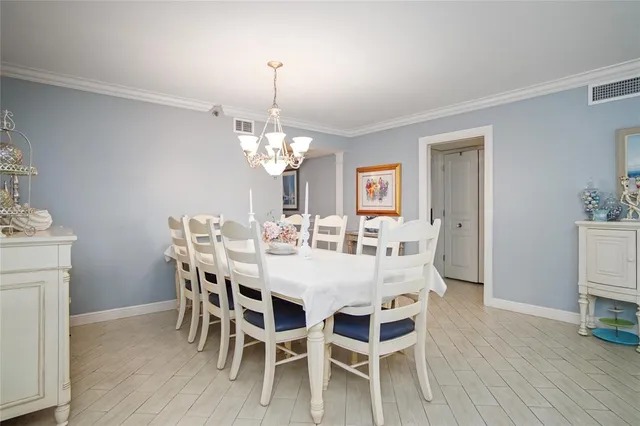 a view of a dining room with furniture wooden floor and chandelier
