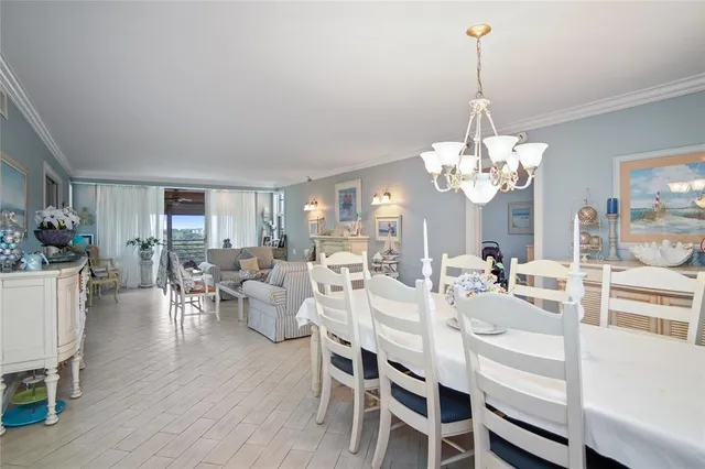 a view of a dining room with furniture wooden floor and chandelier