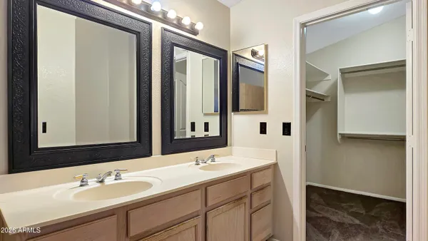 a bathroom with a sink double vanity and a mirror