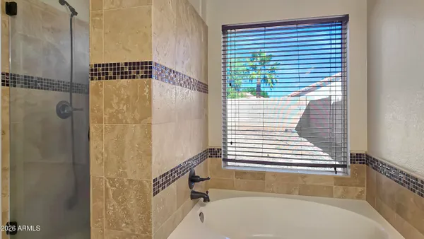 a bathroom with a bathtub and shower
