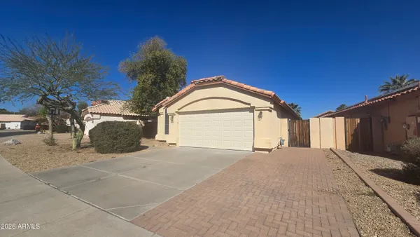 a view of a house with a yard and garage