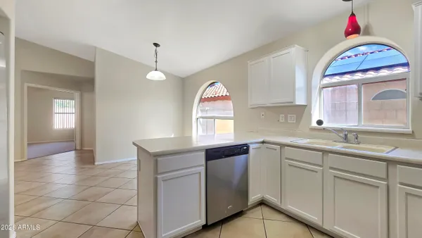 a kitchen with a sink cabinets and window