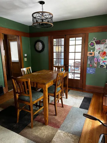 a view of a dining room with furniture and chandelier