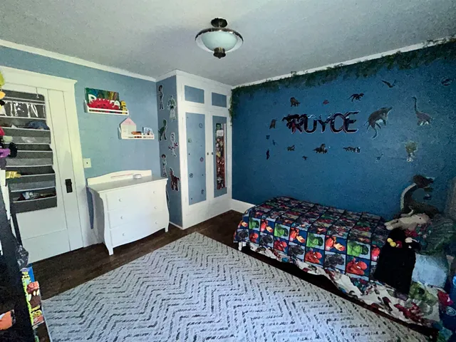 a bedroom with a bed and a dresser