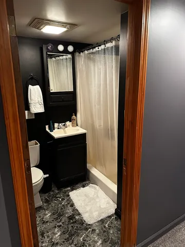 a bathroom with a sink toilet and shower