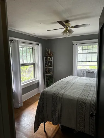 a bedroom with a bed and a large window
