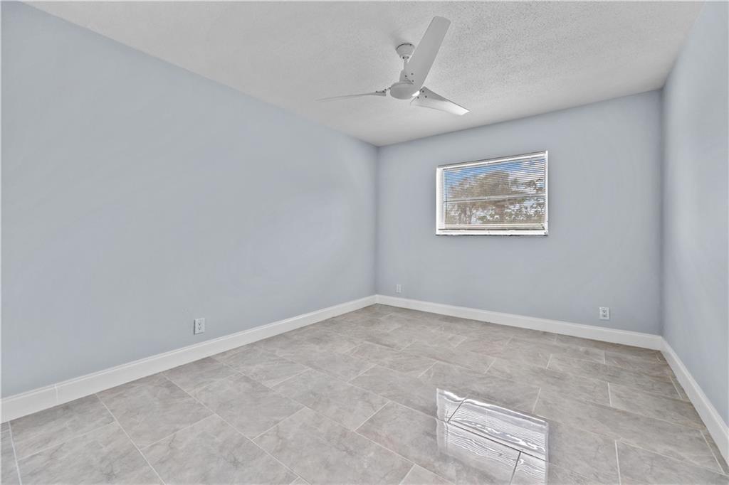 260 Northwest 19th Street, Unit 290 Boca Raton, FL 33432 - Photo 16 of 18 an empty room with a chandelier fan