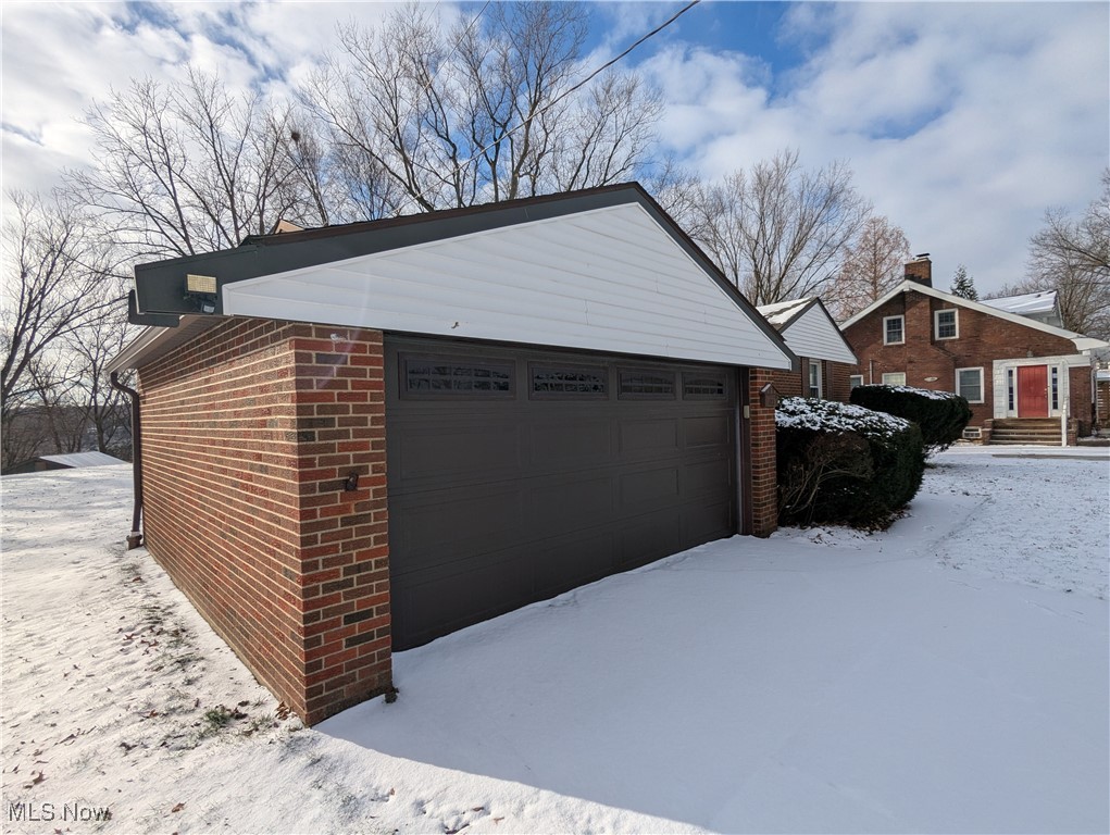 815 East Schaaf Road Independence, OH 44131 - Photo 2 of 36 View of snowy exterior with a garage