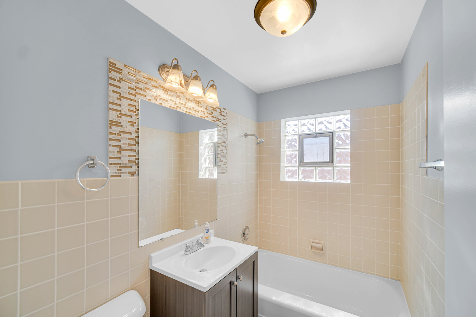 1817 171st Street, Unit 2 Hazel Crest, IL 60429 - Photo 5 of 11 a bathroom with a sink tub and a mirror