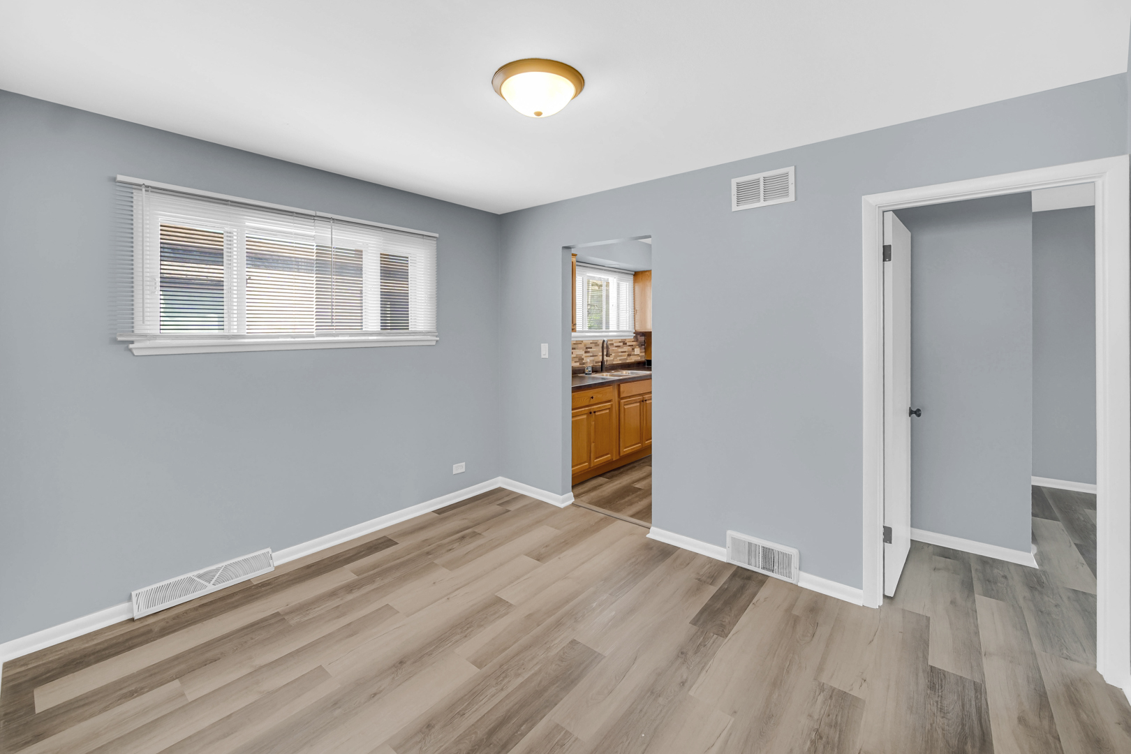 1817 171st Street, Unit 2 Hazel Crest, IL 60429 - Photo 8 of 11 wooden floor in an empty room with a window