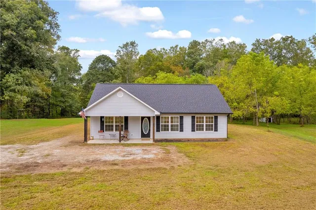 a house with swimming pool in front of it