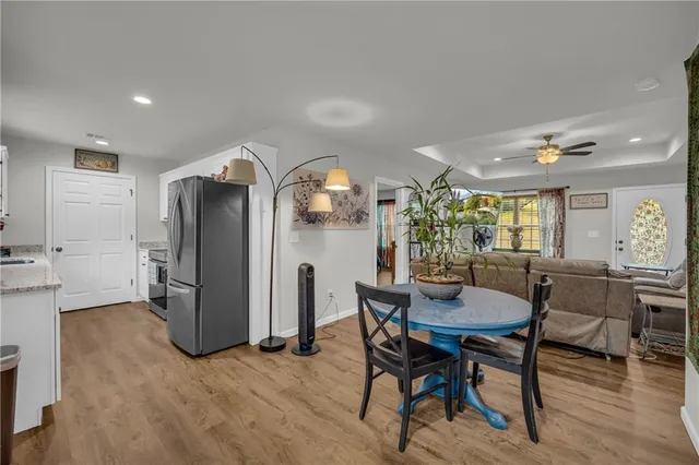 a view of a dining room with furniture and a chandelier