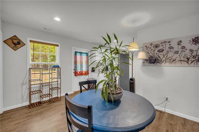 a dining room with furniture and wooden floor