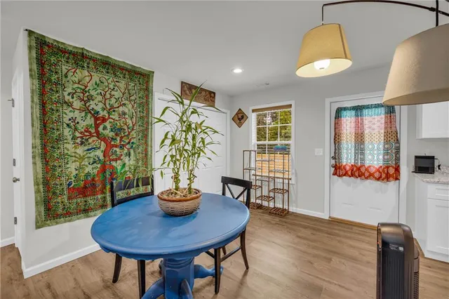a view of a dining room with furniture window and wooden floor