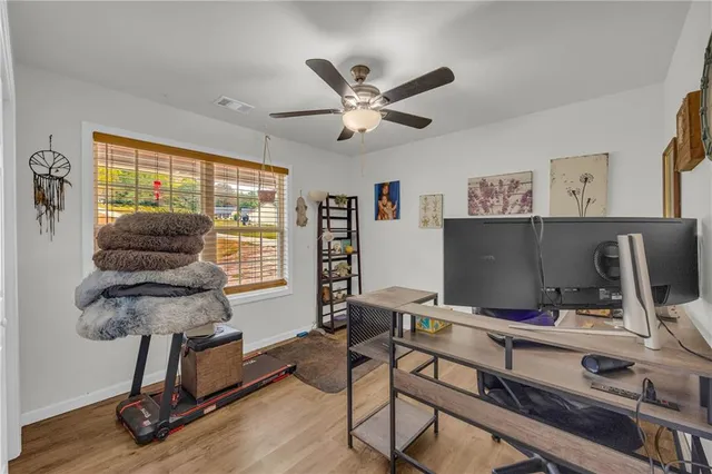 a view of a workspace with furniture and a window