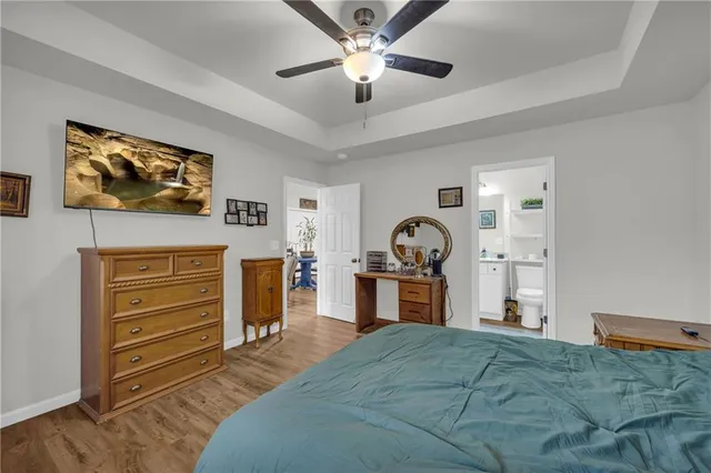 a bedroom with furniture and a flat screen tv
