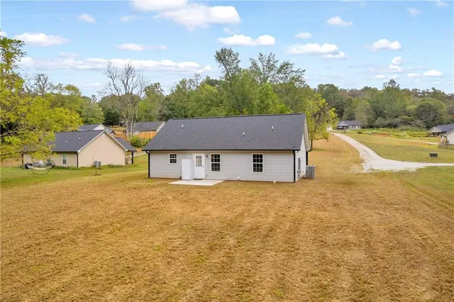 a view of a house with a yard and lake view