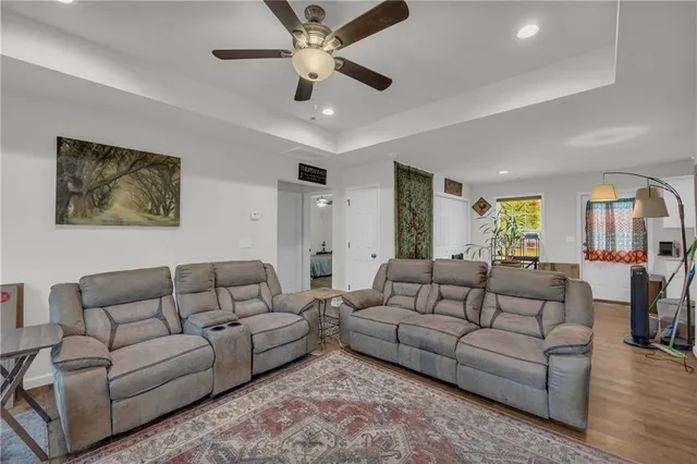 a living room with furniture and a ceiling fan