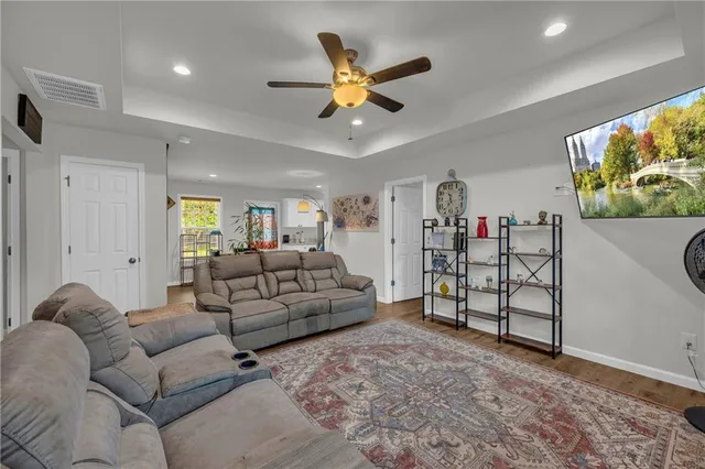 a living room with furniture and ceiling fan