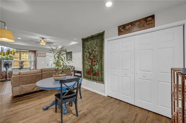 a dining room with furniture and wooden floor