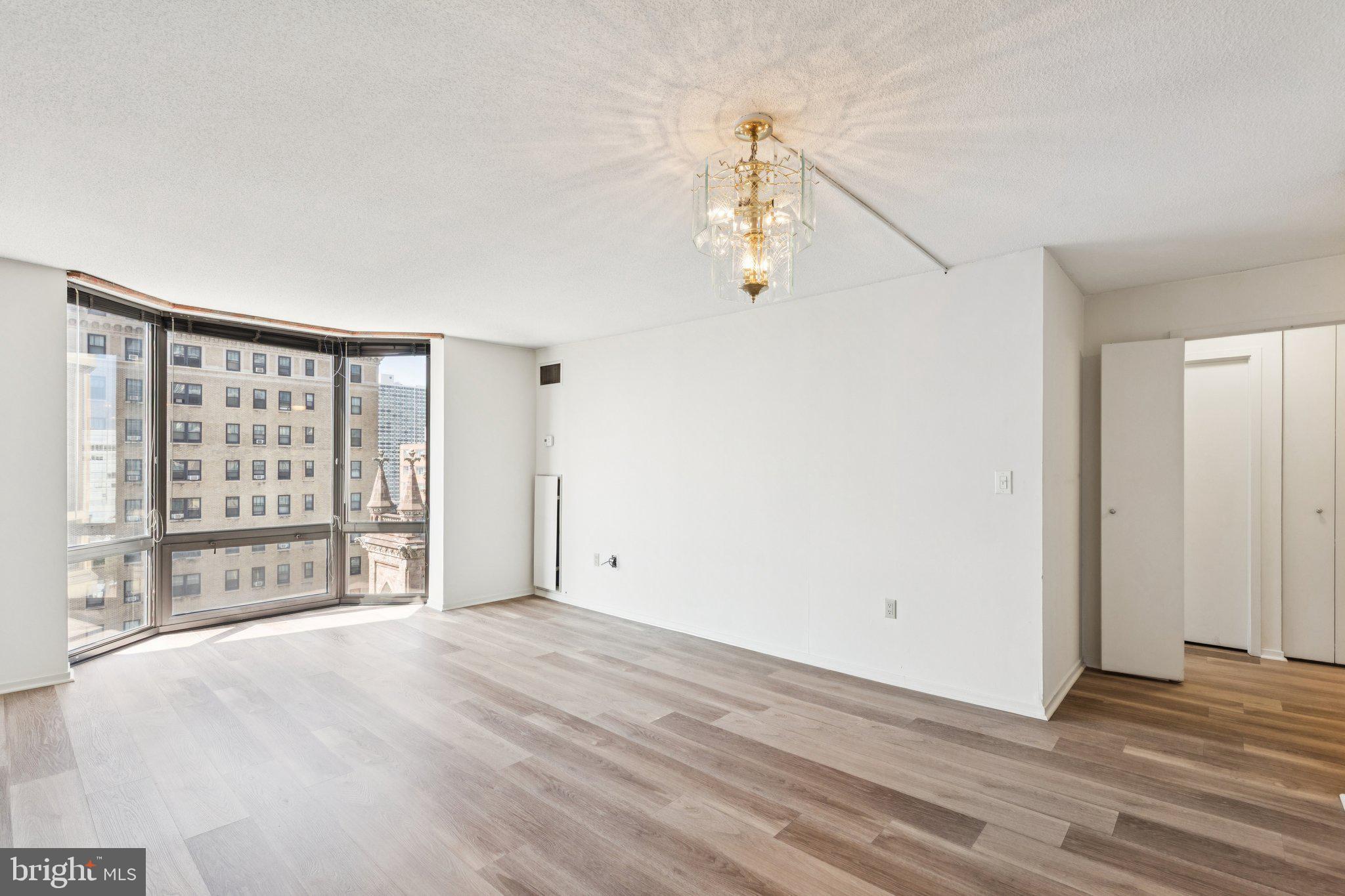 2020 Walnut Street, Unit 14J Philadelphia, PA 19103 - Photo 2 of 25 wooden floor in an empty room with a window