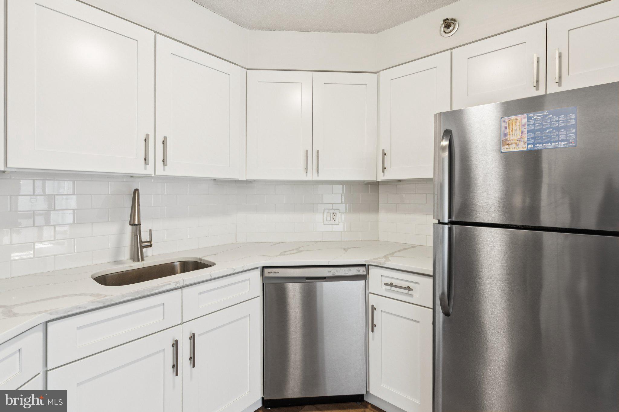 2020 Walnut Street, Unit 14J Philadelphia, PA 19103 - Photo 6 of 25 a kitchen with refrigerator and cabinets
